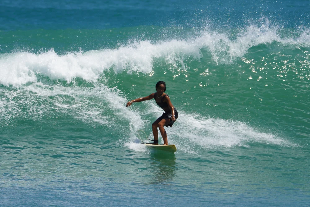 Zazi Betari, Indonesian Winter Athlete, surfing a wave off the beaches of Bali