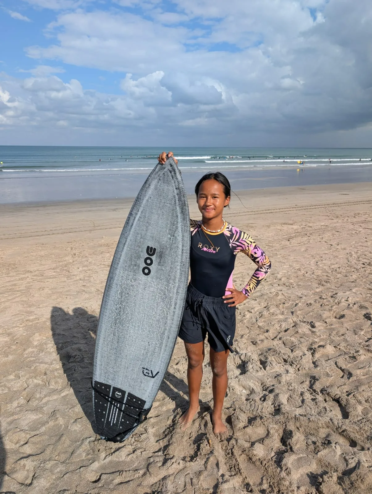 Zazi Betari surfing a wave at Kuta Beach, Bali