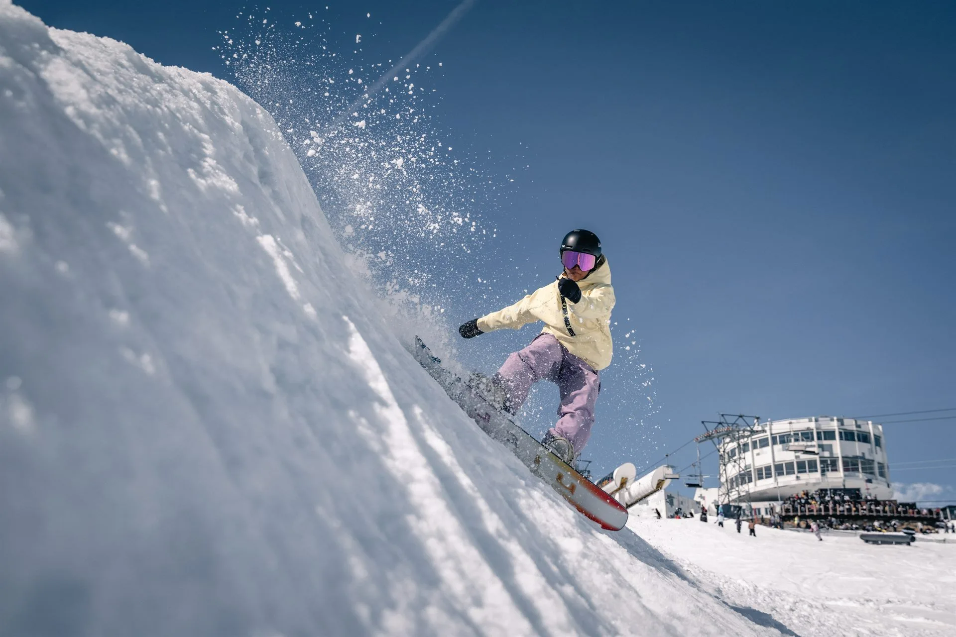 Zazi Betari, Indonesian Snowboard Girl, laying into a heelside carve